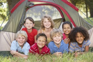 Group Of Children Having Fun In Tent In Countryside